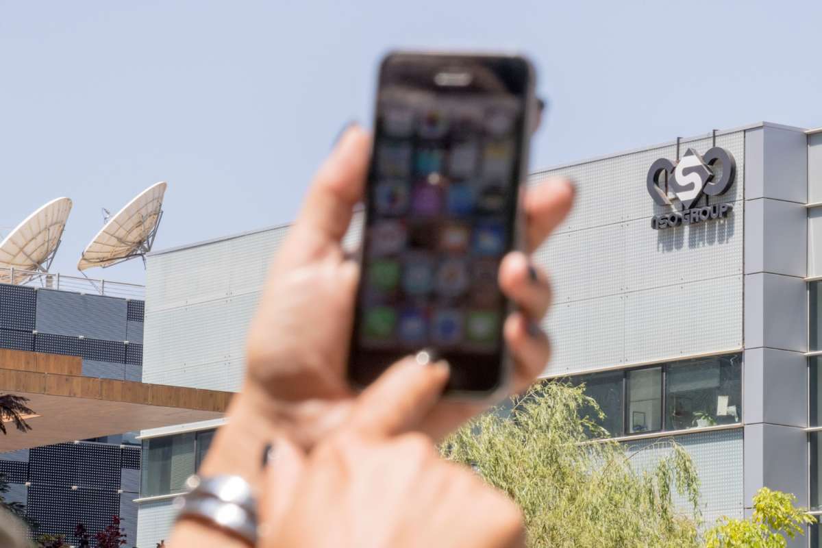 An Israeli citizen uses their iPhone in front of the building housing the Israeli NSO group, on August 28, 2016, in Herzliya, near Tel Aviv.