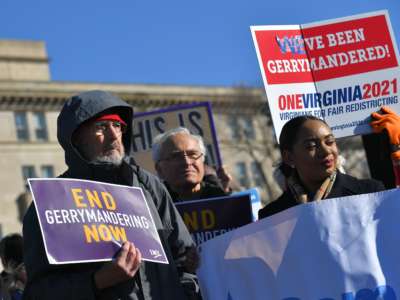 People display signs during a pre-pandemic protest