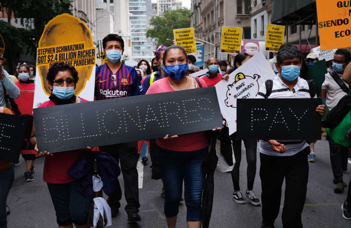People participate in a March on Billionaires event on July 17, 2020, in New York City.