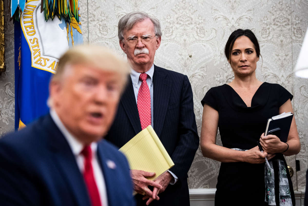 National Security Advisor John Bolton and White House Press Secretary Stephanie Grisham listen as President Donald Trump participates in a meeting in the Oval Office at the White House on July 9, 2019, in Washington, D.C.