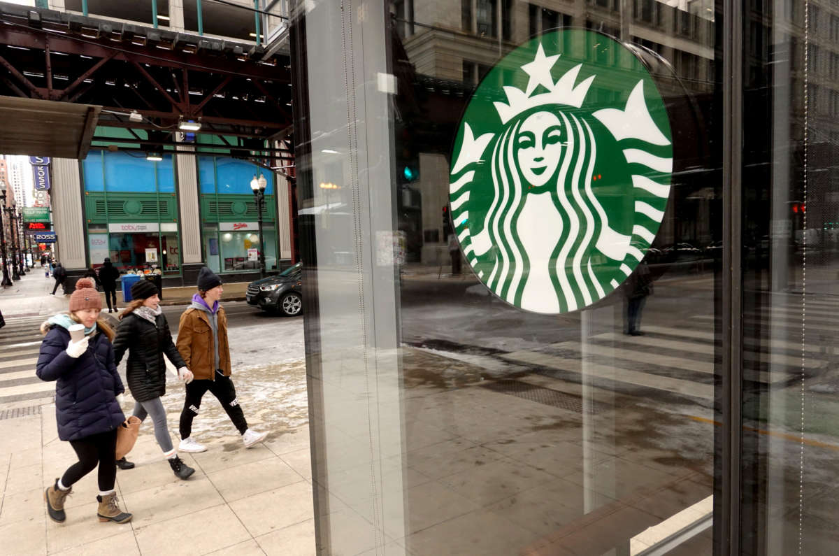 A Starbucks logo hangs in the window of one of the chain's coffee shops in the Loop on January 4, 2022, in Chicago, Illinois.