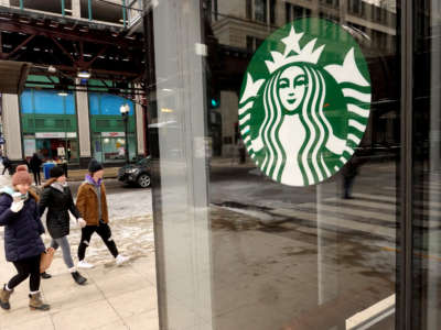 A Starbucks logo hangs in the window of one of the chain's coffee shops in the Loop on January 4, 2022, in Chicago, Illinois.