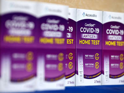 COVID-19 rapid at-home test kits rest on a table at a free distribution event for those who received vaccination shots or booster shots, at Union Station, on January 7, 2022, in Los Angeles, California.