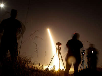 Photographers take pictures of a streak of light trailing off into the night sky as the U.S. military test fires an unarmed intercontinental ballistic missile (ICBM) at Vandenberg Air Force Base, some 130 miles northwest of Los Angeles, California, early on May 3, 2017.