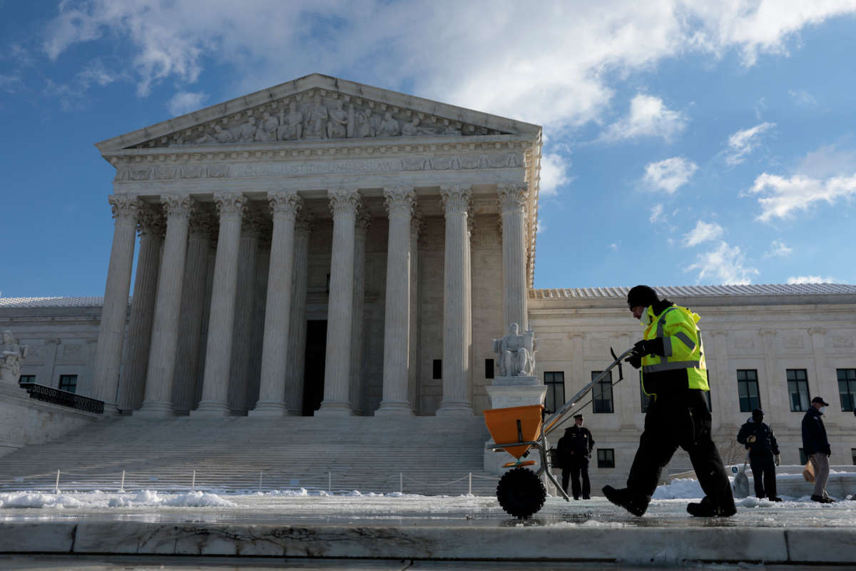 People pour salt on the front plaza of the U.S. Supreme Court on Capitol Hill on January 7, 2022, in Washington, D.C.