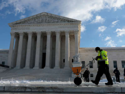 People pour salt on the front plaza of the U.S. Supreme Court on Capitol Hill on January 7, 2022, in Washington, D.C.