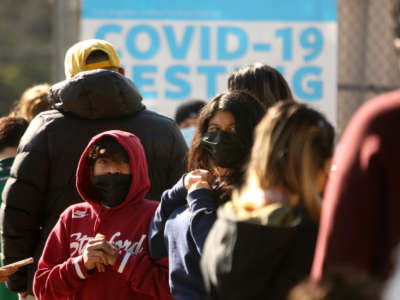 LAUSD students and staff wait in line for a COVID-19 test at a walk-up site at the El Sereno Middle School in the El Sereno neighborhood of Los Angeles, California, on January 4, 2022.