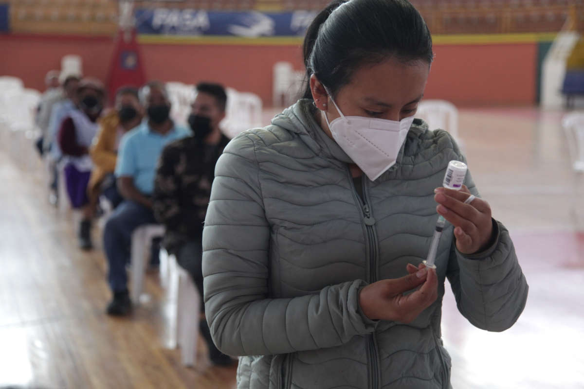A health worker prepares a dose of the AstraZeneca vaccine as part of the COVID-19 vaccination campaign on January 11, 2022, in Cuenca, Ecuador.
