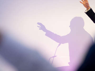 Silhouette of speaker over what backdrop