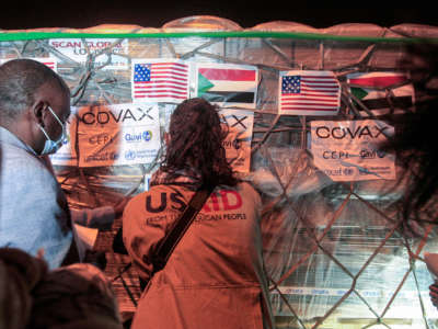 A shipment of vaccines provided for Sudan by COVID-19 Vaccines Global Access (COVAX) is received by local officials at Khartoum International Airport late on August 5, 2021.