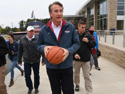 Republican gubernatorial candidate Glenn Youngkin heads to shoot baskets as he makes a stop at Rocky Run Middle School on November 2, 2021, in Chantilly, Virginia.