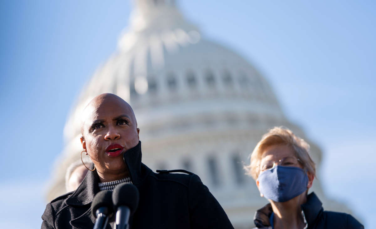 Rep. Ayanna Pressley speaks as Sen. Elizabeth Warren looks on during a press conference about student debt outside the U.S. Capitol on February 4, 2021, in Washington, D.C.