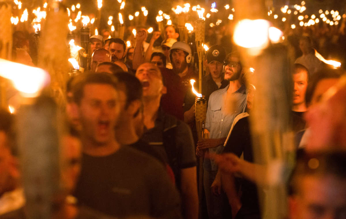 White supremacists march with tiki torchs through the University of Virginia campus on the night before the "Unite the Right" rally in Charlottesville, Virginia, on August 11, 2017.