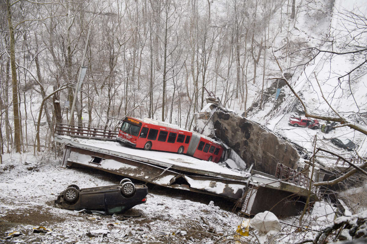 Vehicles, including a Port Authority bus, are left stranded after a bridge collapsed along Forbes Avenue on January 28, 2022, in Pittsburgh, Pennsylvania.