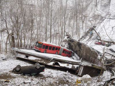 Vehicles, including a Port Authority bus, are left stranded after a bridge collapsed along Forbes Avenue on January 28, 2022, in Pittsburgh, Pennsylvania.