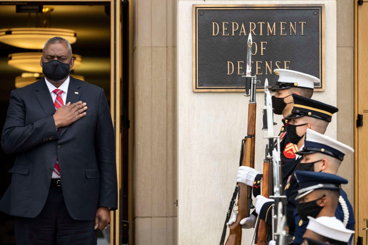Secretary of Defense Lloyd Austin stands for the national anthem during a welcome ceremony for Polish Defense Minister Mariusz Blaszczak at the Pentagon October 6, 2021, in Arlington, Virginia.