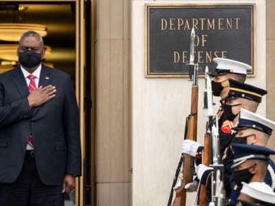 Secretary of Defense Lloyd Austin stands for the national anthem during a welcome ceremony for Polish Defense Minister Mariusz Blaszczak at the Pentagon October 6, 2021, in Arlington, Virginia.