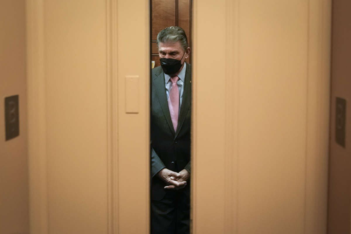 Sen. Joe Manchin gets into an elevator on his way to a vote at the U.S. Capitol on January 5, 2022, in Washington, D.C.