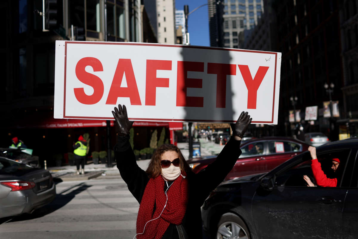 Members of the Chicago Teachers Union and their supporters participate in a car caravan around City Hall to protest against in-person learning in Chicago public schools on January 10, 2022, in Chicago, Illinois.