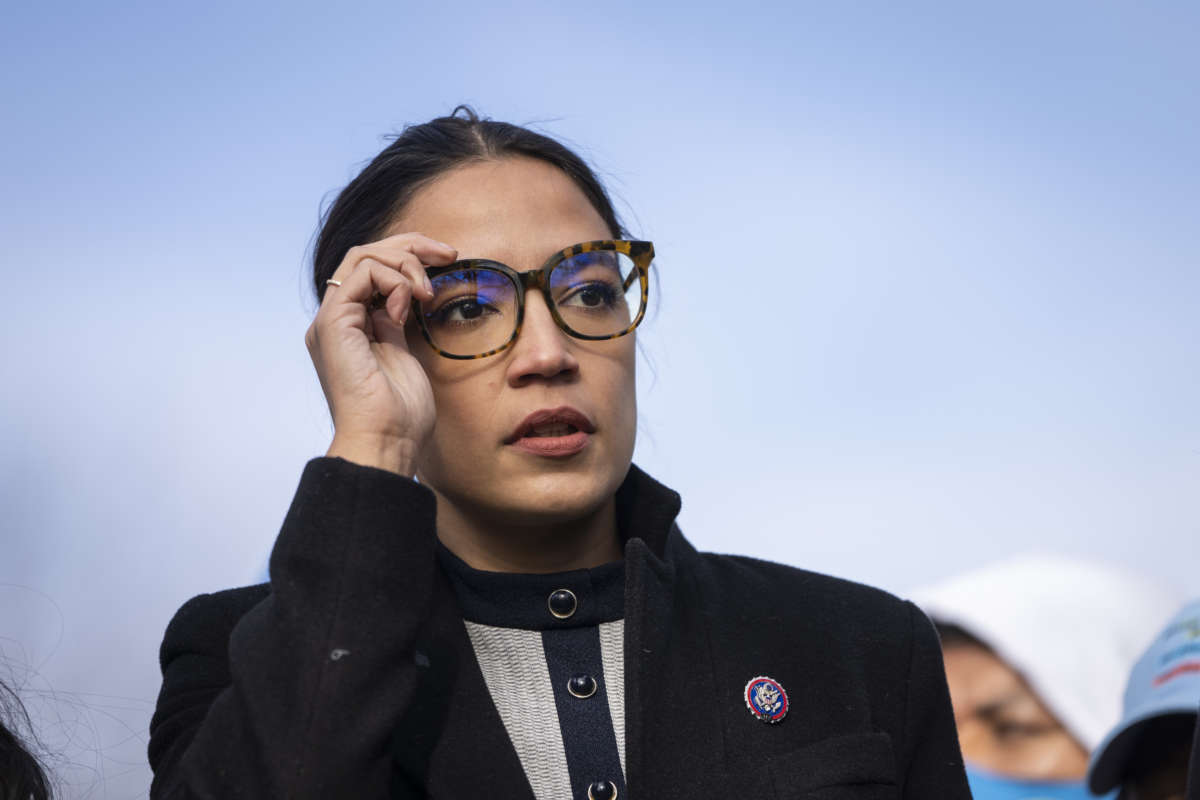 Rep. Alexandria Ocasio-Cortez (D-New York) prepares to speak during a rally for immigration provisions to be included in the Build Back Better Act outside the U.S. Capitol December 7, 2021 in Washington, D.C.