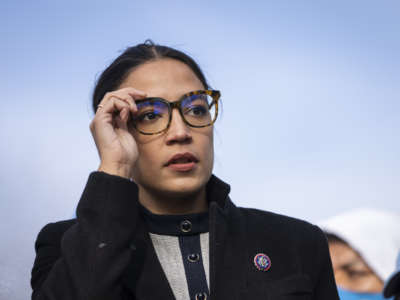 Rep. Alexandria Ocasio-Cortez (D-New York) prepares to speak during a rally for immigration provisions to be included in the Build Back Better Act outside the U.S. Capitol December 7, 2021 in Washington, D.C.