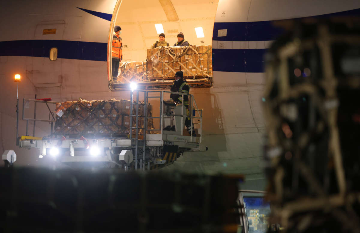 Ground personnel unload weapons, including Javelin anti-tank missiles, and other military hardware delivered on a National Airlines plane by the United States military at Boryspil International Airport near Kyiv on January 25, 2022, in Boryspil, Ukraine.