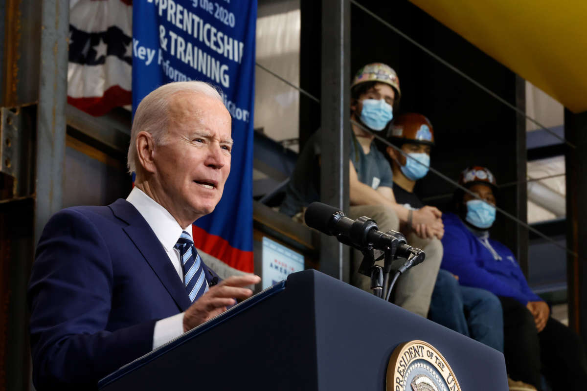 Ironworkers Local 5 sit high on a training platform as they listen to President Joe Biden deliver remarks about project labor agreements at the local on February 4, 2022, in Upper Marlboro, Maryland.