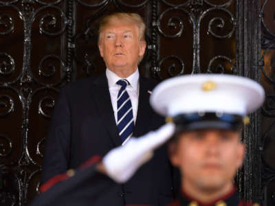 President Donald Trump waits for the arrival of Japan's Prime Minister Shinzo Abe for talks at Trump's Mar-a-Lago resort in Palm Beach, Florida, on April 17, 2018.