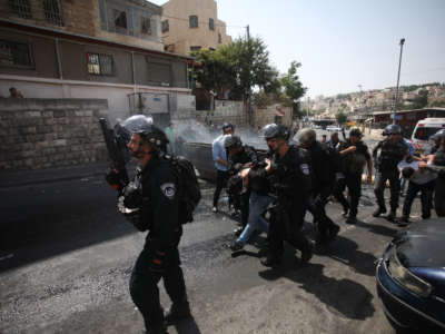 Israeli security forces take Palestinians into custody during a demonstration to protest metal detectors installed by Israeli authorities to Al-Aqsa Mosque Compound, after Palestinians perform Friday prayer on a street at Valley of the Walnuts area in Jerusalem on July 21, 2017.