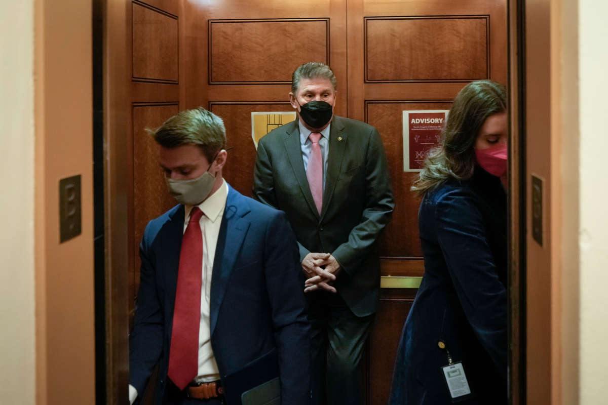 Sen. Joe Manchin gets into an elevator on his way to a vote at the U.S. Capitol on January 5, 2022, in Washington, D.C.