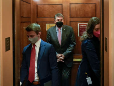 Sen. Joe Manchin gets into an elevator on his way to a vote at the U.S. Capitol on January 5, 2022, in Washington, D.C.
