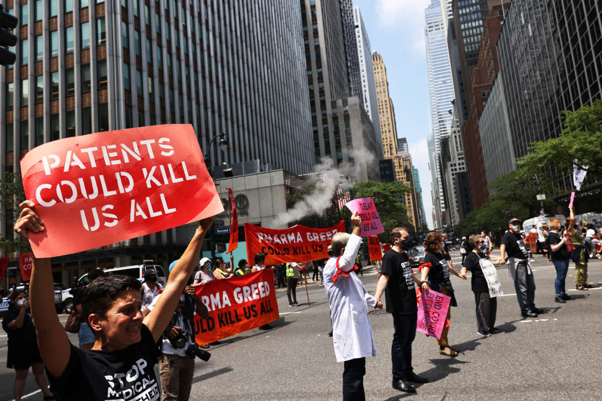 People block traffic during a protest to demand German Chancellor Angela Merkel and Pfizer make the COVID-19 vaccine and treatments more accessible in front of the Pfizer Pharmaceuticals Headquarters on July 14, 2021, in Manhattan in New York City.