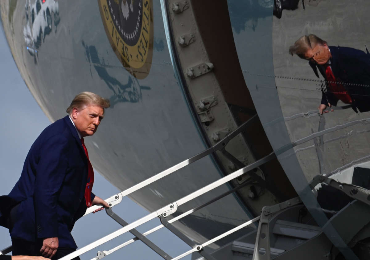 President Donald Trump boards Air Force One at Palm Beach International Airport in West Palm Beach, Florida, on December 31, 2020, as he returns to Washington, D.C., after the Christmas holiday at Mar-a-Lago.