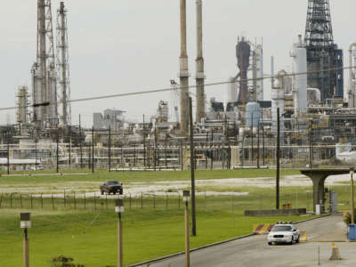 A security vehicle sits outside an Exxon/Mobil refinery on September 23, 2005, in Baytown, Texas.