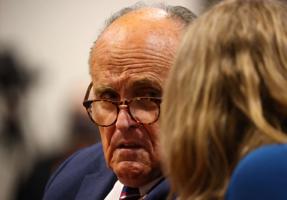 President Donald Trump's personal attorney Rudy Giuliani and Jenna Ellis, a member of the president's legal team, confer during an appearance before the Michigan House Oversight Committee on December 2, 2020, in Lansing, Michigan.