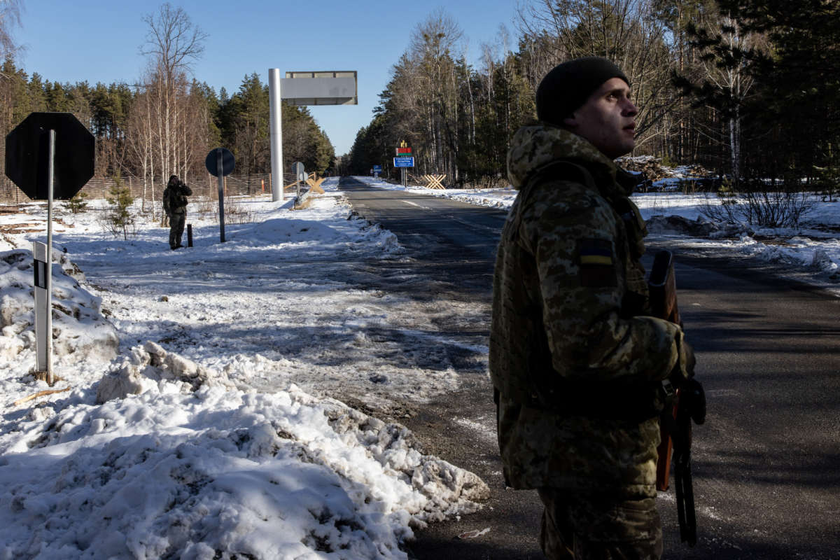 Members of Ukaraine's State Border Guard Service stand at the border crossing between Ukraine and Belarus on February 13, 2022, in Vilcha, Ukraine.