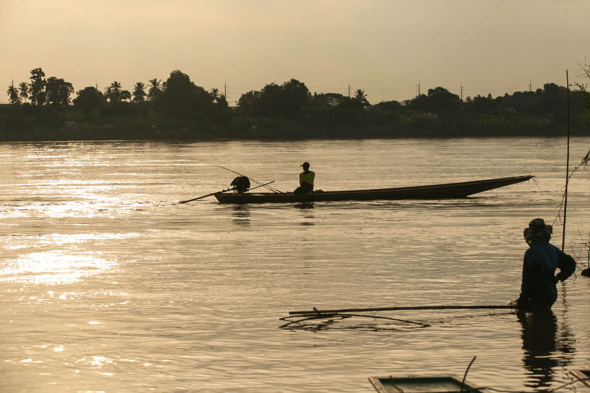 Fishermen catch fish along the Mekong River on the outskirts of Vientiane, Laos, on October 2, 2021.