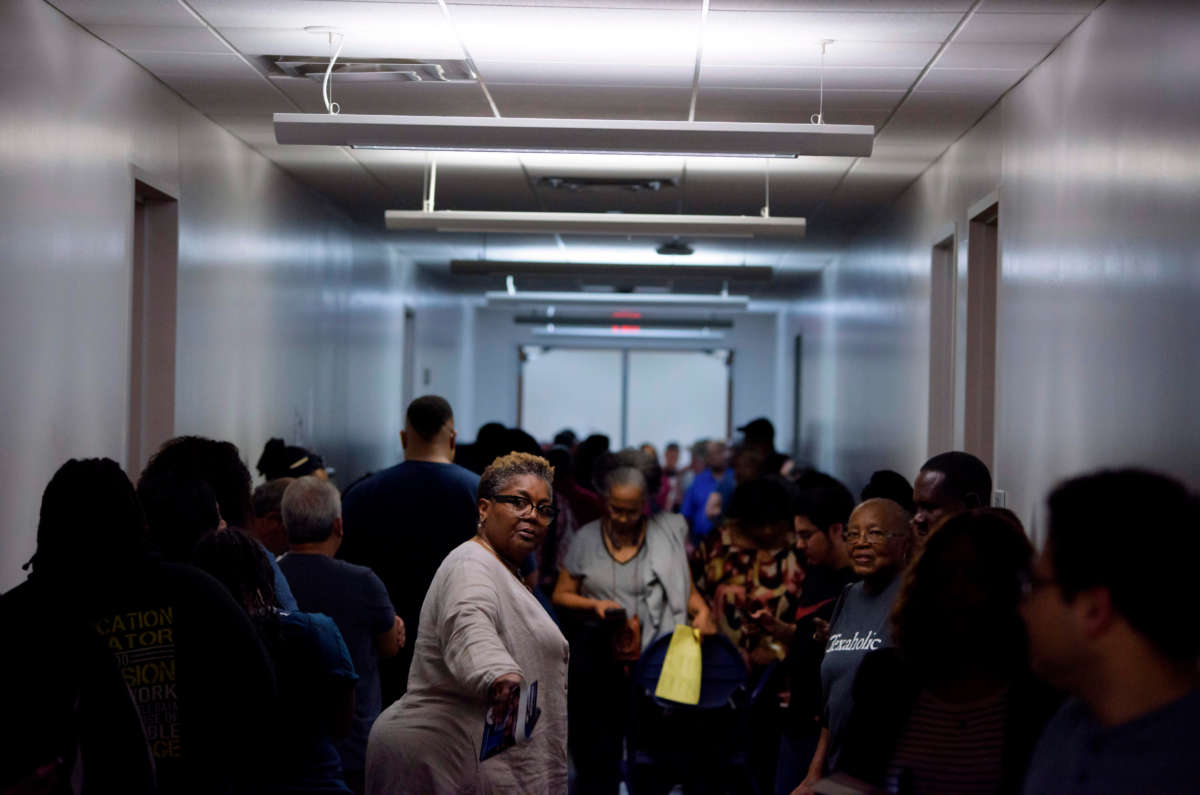 Voters line up at a polling station to cast their ballots during the presidential primary in Houston, Texas on Super Tuesday, March 3, 2020.