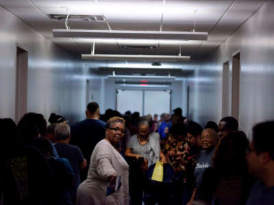 Voters line up at a polling station to cast their ballots during the presidential primary in Houston, Texas on Super Tuesday, March 3, 2020.