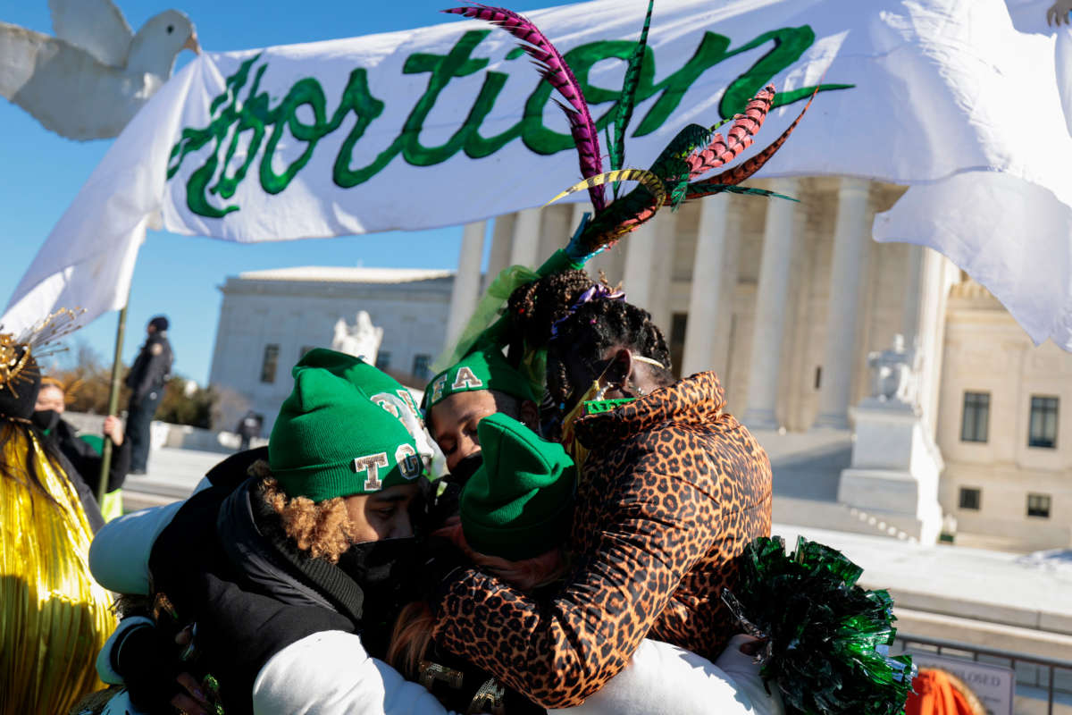 Activists hug during a flash mob put on by the group "Act for Abortion” in front of the U.S. Supreme Court on January 22, 2022, in Washington, D.C.