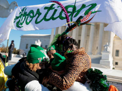 Activists hug during a flash mob put on by the group "Act for Abortion” in front of the U.S. Supreme Court on January 22, 2022, in Washington, D.C.