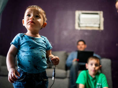 In the San Joaquin Valley, Elizabeth Elias and Jose Espinoza with their children, Gerardo, 6, and Josue, 1, at their home in Porterville, California, on March 18, 2021.