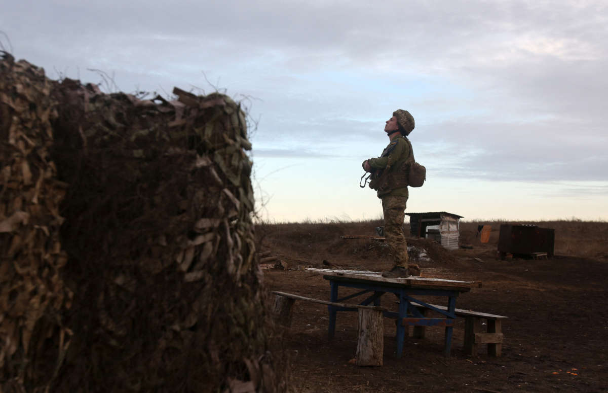 A soldier of the Ukrainian Military Forces watches on position on the front line with Russia-backed separatists not far from Novognativka village in the Donetsk region on February 19, 2022.