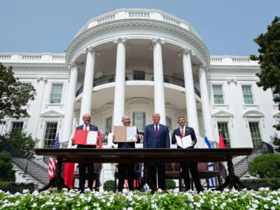 From left, Bahrain Foreign Minister Abdullatif al-Zayani, Israeli Prime Minister Benjamin Netanyahu, President Donald Trump, and UAE Foreign Minister Abdullah bin Zayed Al-Nahyan hold up documents after participating in the signing of the Abraham Accords at the White House in Washington, D.C., on September 15, 2020.