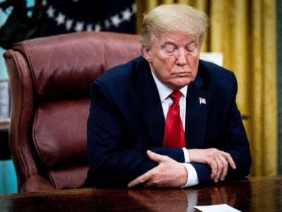 President Donald Trump sits a the Resolute Desk in the Oval Office at the White House on May 1, 2020, in Washington, D.C.