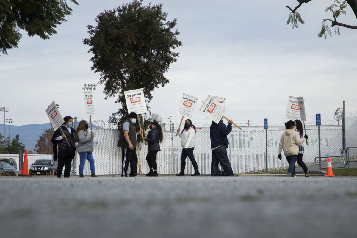 Workers at Jon Donaire desserts factory in Santa Fe Springs, California, picket in front of the company on January 10, 2022.