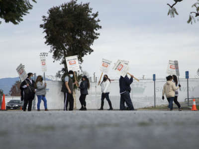 Workers at Jon Donaire desserts factory in Santa Fe Springs, California, picket in front of the company on January 10, 2022.