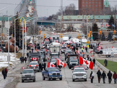 Protestors and supporters set up at a blockade at the foot of the Ambassador Bridge, sealing off the flow of commercial traffic over the bridge into Canada from Detroit, on February 10, 2022, in Windsor, Canada.