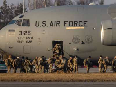 U.S. soldiers disembark from a C-17 Globemaster cargo plane on the tarmac of Rzeszow-Jasionka Airport, south eastern Poland, on February 16, 2022. The soldiers are part of a deployment of several thousand sent to bolster NATO's eastern flank in response to tensions with Russia.