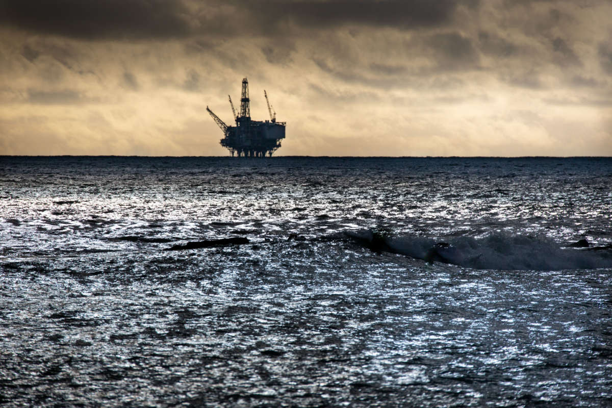 An offshore oil rig is viewed from Refugio Beach State Park as a storm gathers along the horizon on December 26, 2021, in Goleta, California.